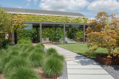 Inspiration for a large contemporary partial sun backyard concrete paver landscaping in Los Angeles for summer.