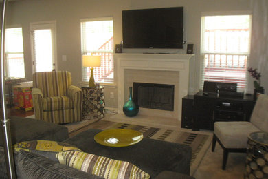 Living room - mid-sized contemporary enclosed carpeted and gray floor living room idea in Columbus with gray walls, a standard fireplace, a stone fireplace and a wall-mounted tv