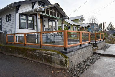 Inspiration for a mid-sized concrete paver and metal fence landscaping in Portland.
