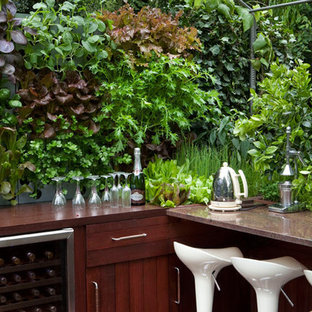 Small contemporary rooftop formal garden in Hertfordshire with a vertical garden and decking.