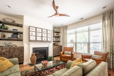 Example of a mid-sized urban living room design in Raleigh with a concealed tv