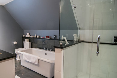 Mid-sized trendy master white tile and ceramic tile slate floor bathroom photo in Milwaukee with a two-piece toilet, gray walls, an undermount sink and quartz countertops