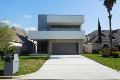 Mid-sized minimalist multicolored two-story mixed siding flat roof photo in Houston