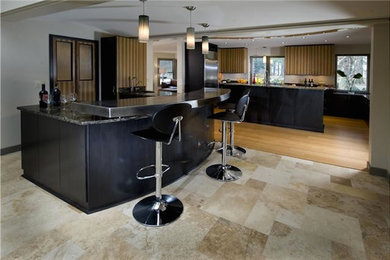 Inspiration for a huge modern single-wall medium tone wood floor and beige floor open concept kitchen remodel in Other with a double-bowl sink, flat-panel cabinets, light wood cabinets, granite countertops, stainless steel appliances and an island