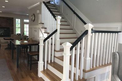 Example of a large transitional wooden l-shaped wood railing staircase design in Boston with painted risers