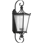 Progress Lighting - Cadence Collection Black 1-Light Large Wall Lantern - This wall lantern has a decorative and fashion-orientated design with modern classic styling. The clear water seeded glass shade gives off a soft glow of light. The beautiful black-finished lantern frame gently holds the shade in place.