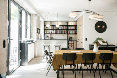 Photo of a scandinavian dining room in Paris with light hardwood floors.