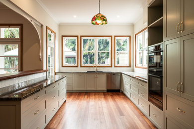 This is an example of a large traditional kitchen in Other with granite benchtops.