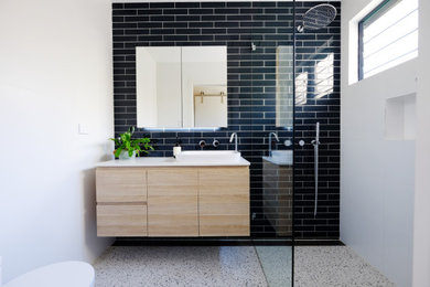 This is an example of a small contemporary master bathroom in Sydney with flat-panel cabinets, light wood cabinets, an open shower, a one-piece toilet, blue tile, porcelain tile, white walls, porcelain floors, an integrated sink, engineered quartz benchtops, white floor, an open shower, white benchtops, a niche, a single vanity and a floating vanity.