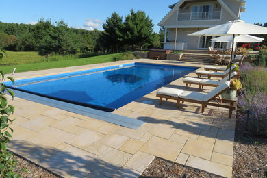 Large minimalist backyard concrete and rectangular pool photo in Minneapolis