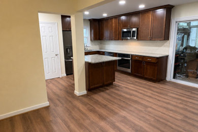 Inspiration for a mid-sized rustic kitchen remodel in Richmond with an island