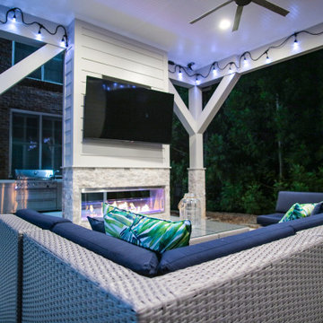 Cozy Outdoor Lounge with Fireplace & String Lights