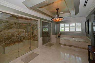 Expansive transitional master bathroom in Miami with marble benchtops, a double shower, beige tile, beige walls, marble floors, beige floor, a drop-in tub, stone slab and a hinged shower door.