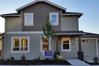 Mid-sized contemporary green two-story concrete exterior home idea in Denver with a hip roof