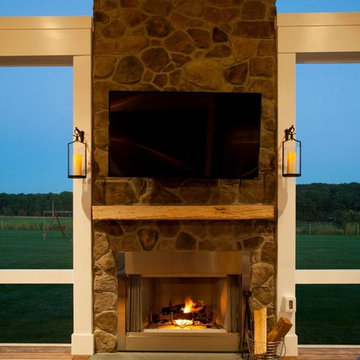 Design Builders screened porch with stone fireplace & Ipe deck in Sykesville MD