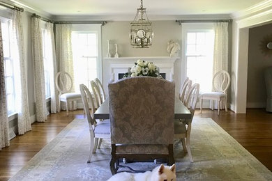 Inspiration for a mid-sized farmhouse medium tone wood floor dining room remodel in Philadelphia with a standard fireplace