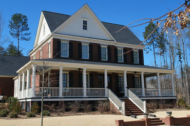 Example of a large transitional two-story brick gable roof design in Birmingham with a shingle roof