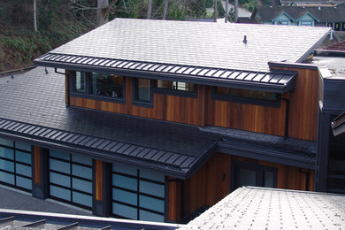 Photo of an expansive transitional two-storey brown exterior in Vancouver with wood siding and a gable roof.