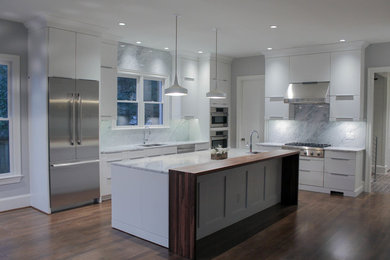 Inspiration for a mid-sized contemporary u-shaped medium tone wood floor open concept kitchen remodel in Raleigh with an undermount sink, flat-panel cabinets, white cabinets, marble countertops, gray backsplash, stone slab backsplash, stainless steel appliances and an island
