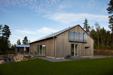 Inspiration for a mid-sized scandinavian one-storey grey exterior in Stockholm with wood siding.