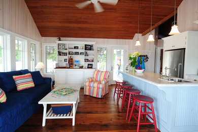 Open concept kitchen - small coastal galley dark wood floor and brown floor open concept kitchen idea in Other with an undermount sink, shaker cabinets, white cabinets, quartz countertops, stainless steel appliances and an island