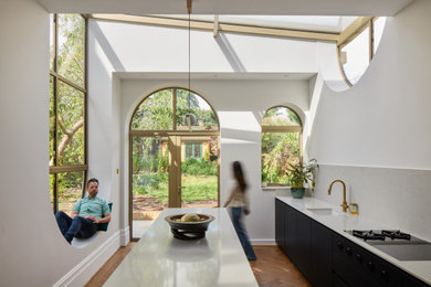 Inspiration for a contemporary kitchen in London with feature lighting.