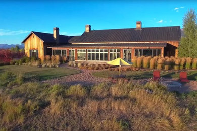 Large transitional brown one-story wood gable roof idea in Jackson
