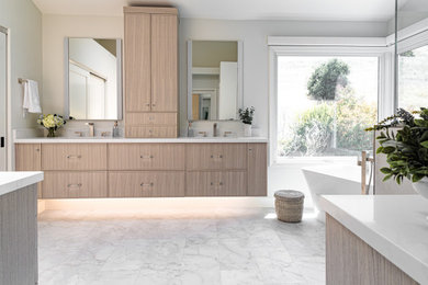 Example of a large transitional master white tile porcelain tile, white floor and double-sink bathroom design in San Francisco with a bidet, an undermount sink, quartz countertops, white countertops, a niche, a floating vanity and light wood cabinets