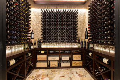 This is an example of a contemporary wine cellar in Dallas with storage racks, beige floor and ceramic floors.