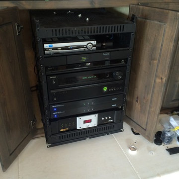 Sliding equipment rack with cooling system. Houses audio system for entire home!