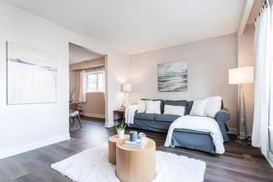 Living room - large traditional loft-style vinyl floor and brown floor living room idea in Toronto with white walls