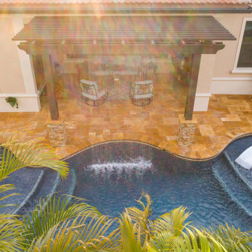 Custom Pool with Spa, Sun Shelf, and Pebble Tec Finish in Parkland Fla.