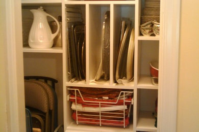 Example of a small trendy gender-neutral reach-in closet design in Louisville with open cabinets and white cabinets