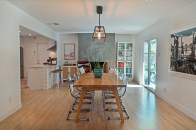 Example of a 1960s light wood floor and beige floor kitchen/dining room combo design in Dallas with a standard fireplace