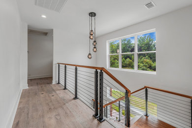Staircase - mid-sized farmhouse wooden l-shaped mixed material railing and wall paneling staircase idea in Little Rock with wooden risers