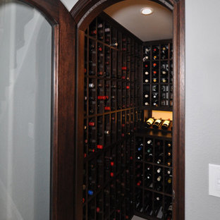 Small modern wine cellar in San Diego with porcelain flooring and storage racks.