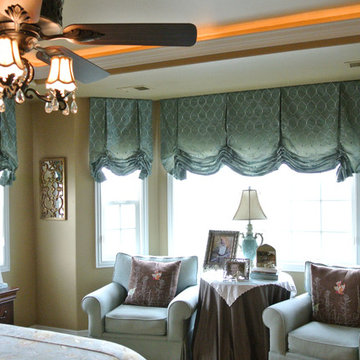 Dropped end roman valances in a bay