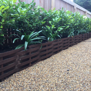 Corten steel raised bed created using steel strips, posts and fixings supplied b