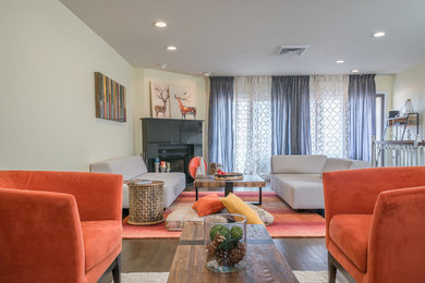 Inspiration for a large contemporary formal and enclosed medium tone wood floor and brown floor living room remodel in New York with beige walls, a corner fireplace, a stone fireplace and no tv