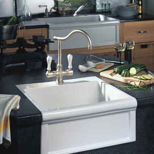 Small transitional kitchen pantry photos - Small transitional single-wall kitchen pantry photo with a farmhouse sink, flat-panel cabinets, medium tone wood cabinets, granite countertops, an island and stainless steel appliances