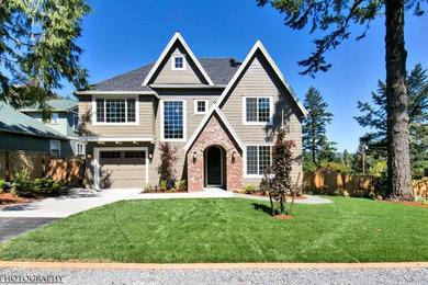 Example of a mid-sized classic beige two-story exterior home design in Portland