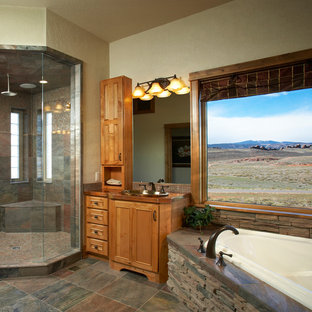Example of a large arts and crafts master multicolored tile and stone tile porcelain floor and multicolored floor bathroom design in Denver with beaded inset cabinets, brown cabinets, beige walls, a drop-in sink, copper countertops and a hinged shower door