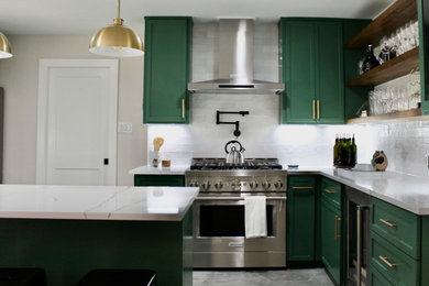 Eat-in kitchen - large mid-century modern u-shaped porcelain tile and gray floor eat-in kitchen idea in Houston with an undermount sink, shaker cabinets, green cabinets, quartz countertops, white backsplash, porcelain backsplash, stainless steel appliances, an island and white countertops