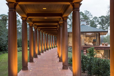 Huge mountain style two-story glass house exterior photo in Atlanta with a hip roof and a tile roof