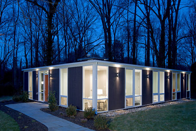 Example of a trendy blue one-story wood flat roof design in DC Metro