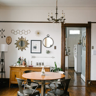 Dining room - eclectic medium tone wood floor dining room idea in Chicago with white walls