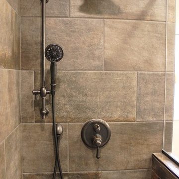 Moline, IL Bath Remodel With Gray Stained Cherry Vanity and Pebble Tiled Shower