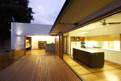 This is an example of a mid-sized contemporary backyard deck in Melbourne.