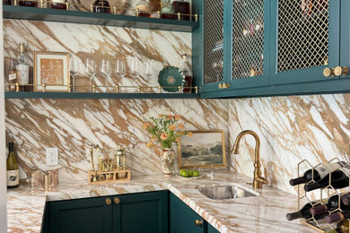 Inspiration for a timeless u-shaped dark wood floor and brown floor home bar remodel in Houston with an undermount sink, recessed-panel cabinets, blue cabinets, beige backsplash, stone slab backsplash and beige countertops