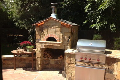 Photo of a backyard patio in Denver with a fire feature and tile.